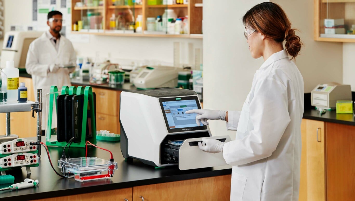 Scientist opening sample drawer on Bio-Rad Geldoc Go