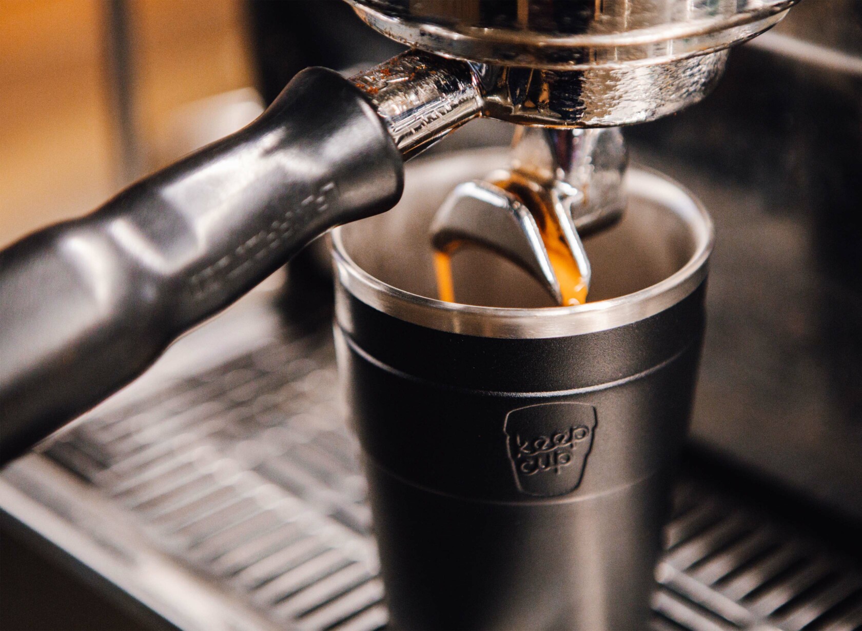 Coffee machine dispensing fresh coffee into KeepCup thermal
