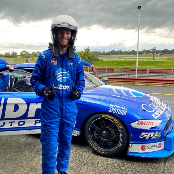 Cobalt staff member posing in front of CoolDrive Mustang Supercar